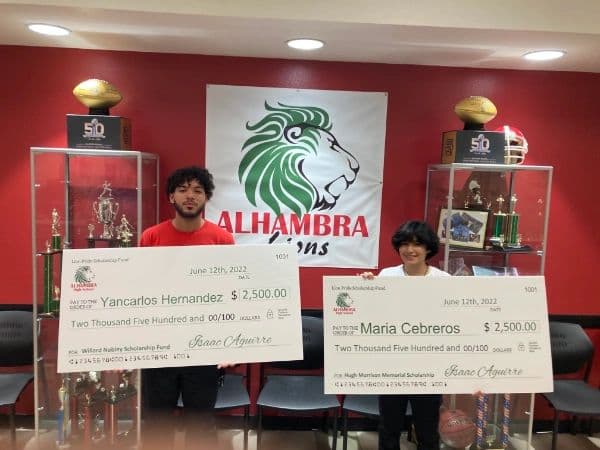 Yancarlos Hernandez and Maria Cebreros with their 2022 Lion Pride Scholarship Fund cheques