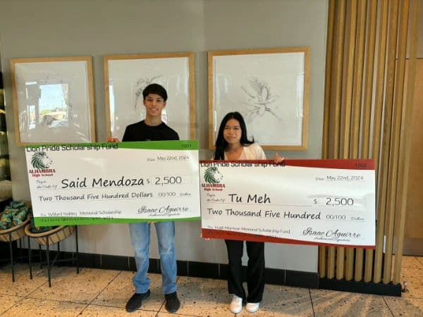 Said Mendoza and Tu Meh with their 2024 Lion Pride Scholarship Fund cheques